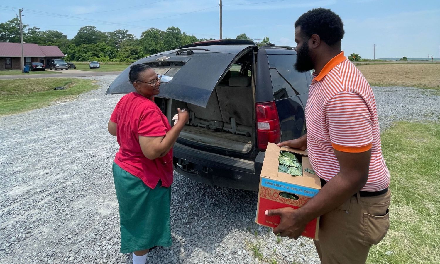 A Coahoma County community member receives a Good Food at Home produce box.